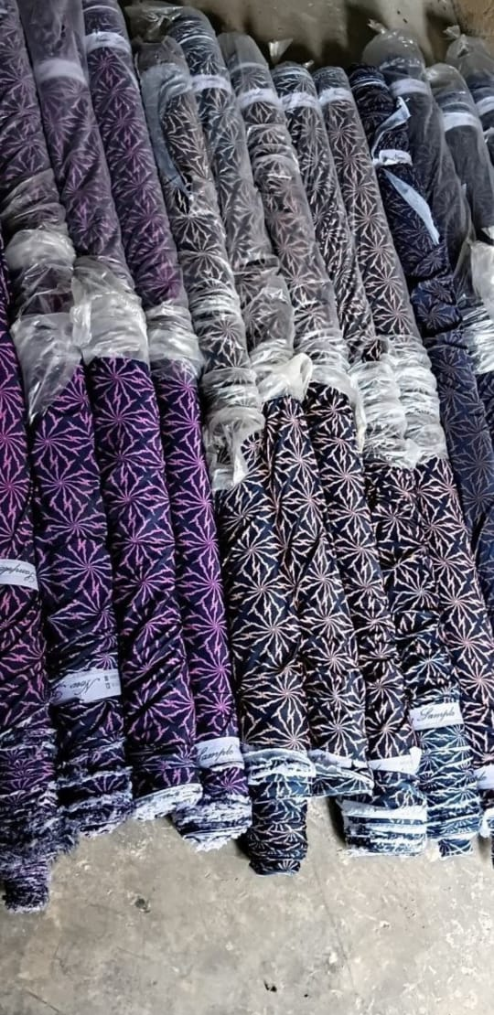 Rolls of purple and navy starburst 9F fabric